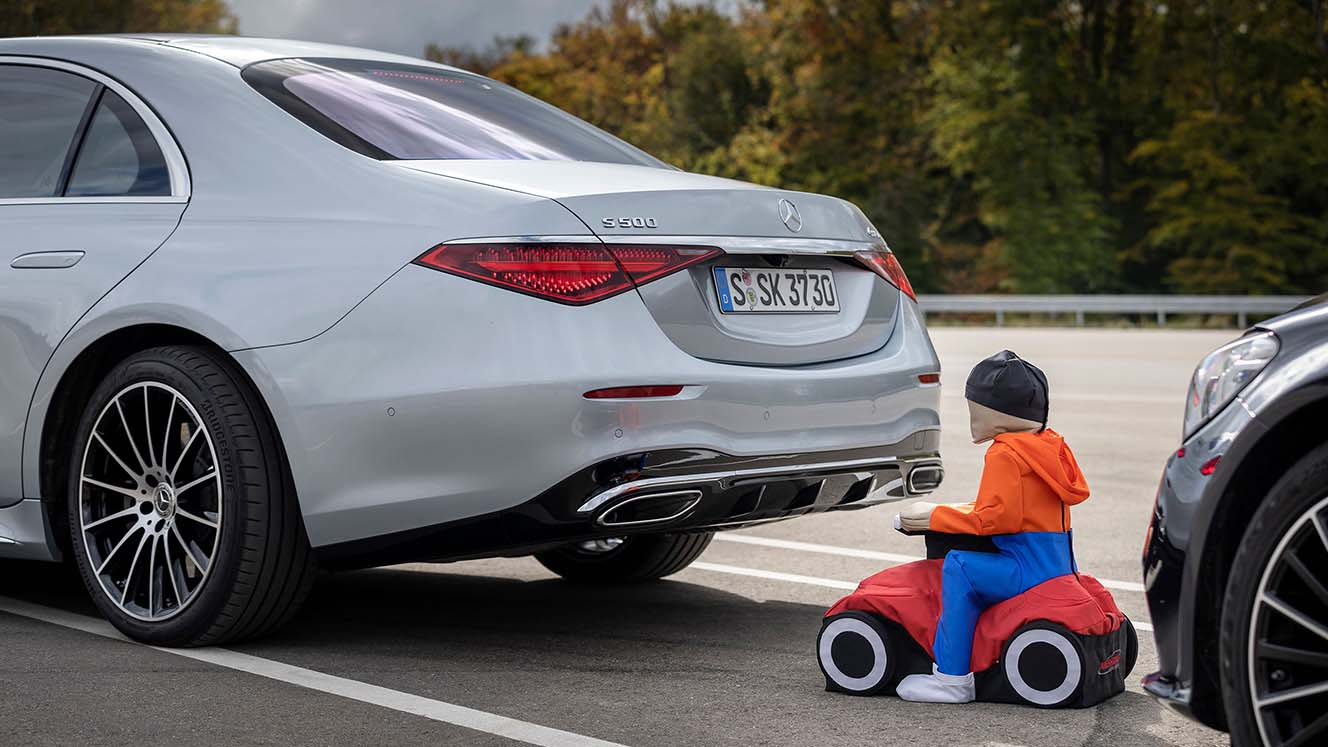 Rückfahrassistent im Test mit einem Dummy-Bobbycar hinter dem Auto